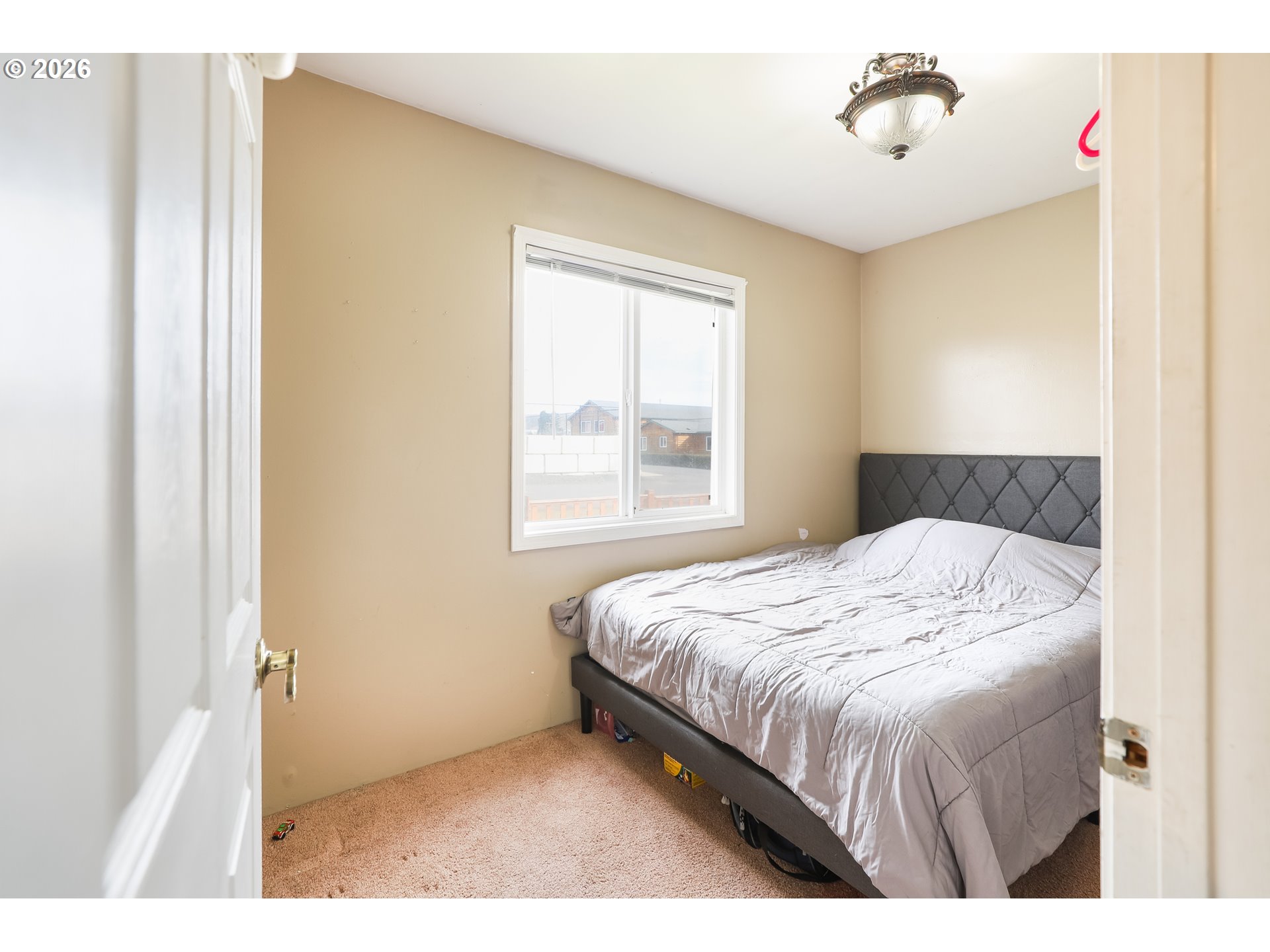 409 Northeast Court Street Dufur, OR 97021 - Photo 14 of 38 a bedroom with a bed and a window