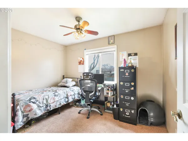 a bedroom with bed and a chandelier