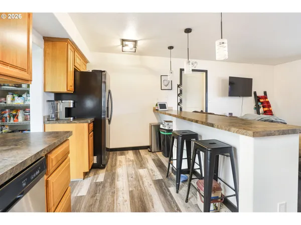 a kitchen with sink and refrigerator