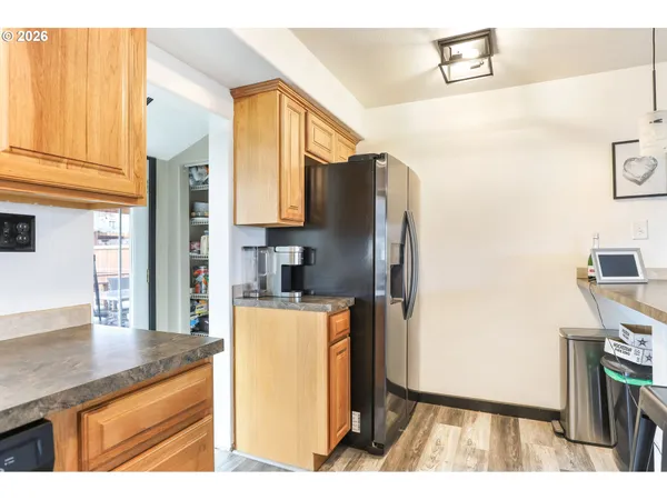 a kitchen with stainless steel appliances granite countertop a refrigerator a sink and a stove