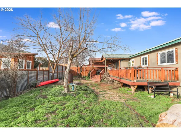 a view of a house with backyard and sitting area