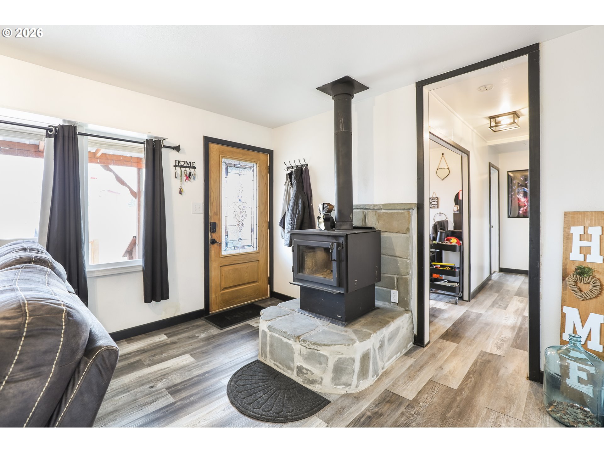 409 Northeast Court Street Dufur, OR 97021 - Photo 3 of 38 a living room with furniture a flat screen tv and a fireplace