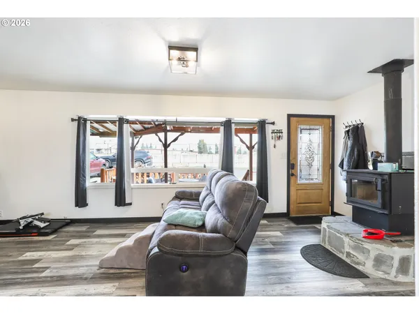 a living room with furniture flat screen tv and a large window