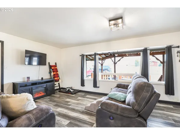 a living room with furniture window and a flat screen tv