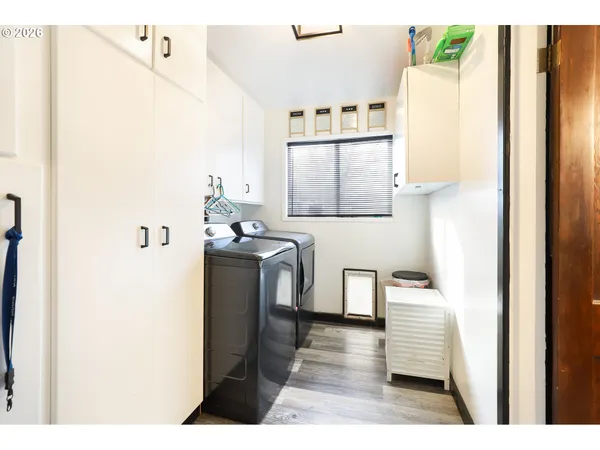 a utility room with cabinets washer and dryer