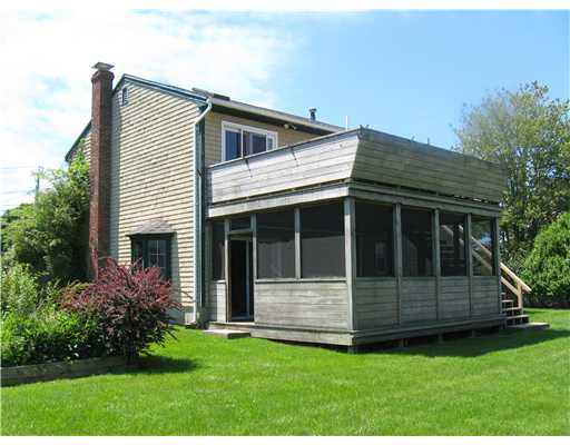 21 Sand Hill Cove Road Narragansett, RI 02882 - Photo 2 of 16 Exterior Back. Large screened in porch area overlooks private yard.