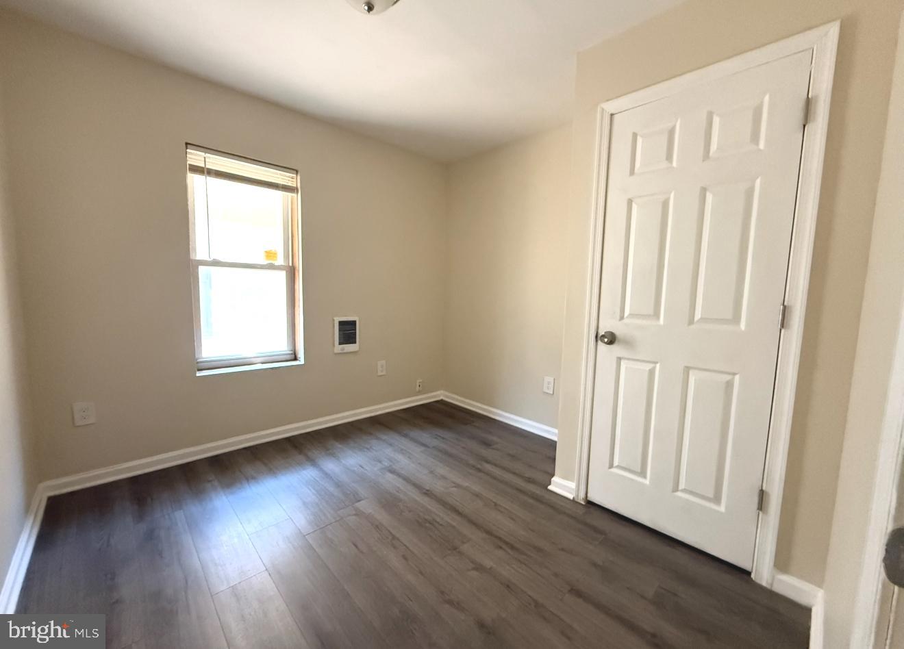 15 West 10th Street, Unit B Marcus Hook, PA 19061 - Photo 12 of 12 an empty room with wooden floor and windows