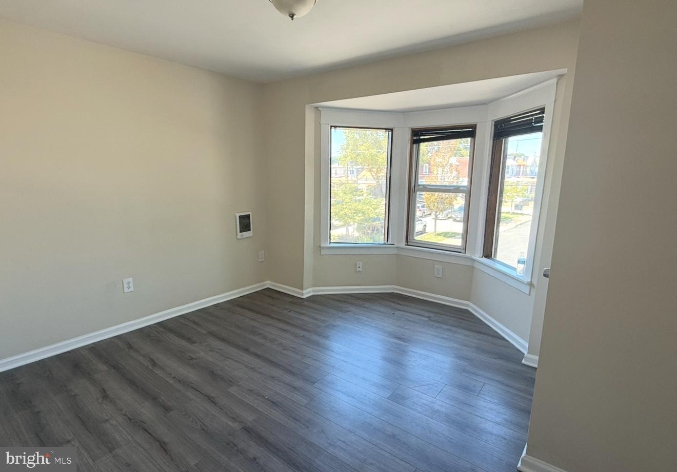 15 West 10th Street, Unit B Marcus Hook, PA 19061 - Photo 6 of 12 an empty room with wooden floor and windows