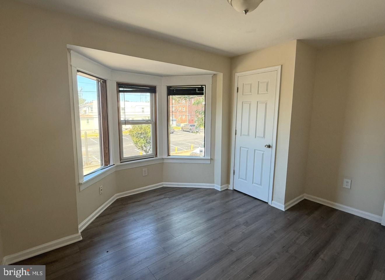 15 West 10th Street, Unit B Marcus Hook, PA 19061 - Photo 7 of 12 a view of an empty room with wooden floor and a window