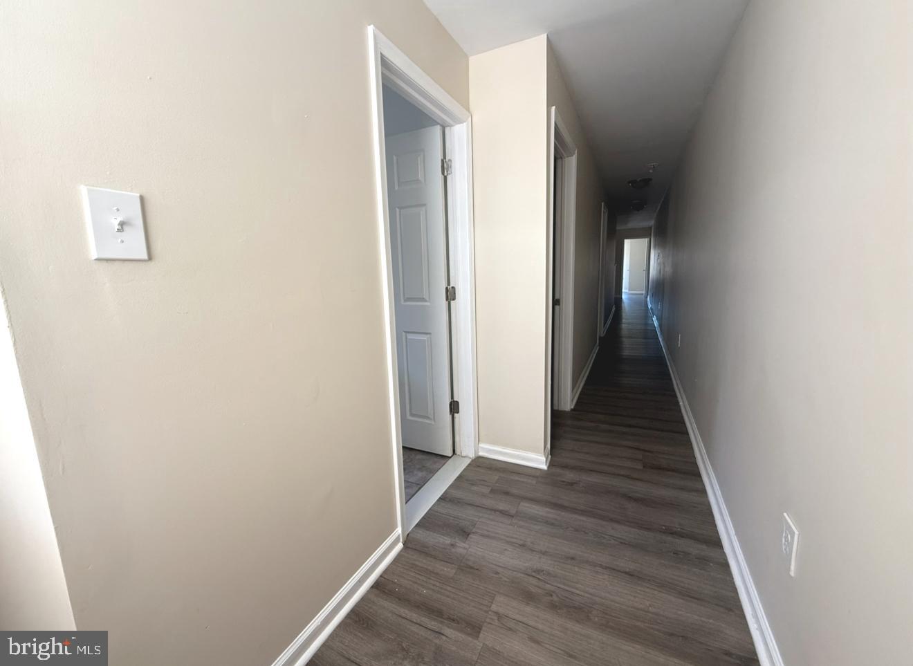 15 West 10th Street, Unit B Marcus Hook, PA 19061 - Photo 8 of 12 a view of a hallway with wooden floor