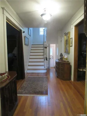 a view of a hallway view with wooden floor and furniture
