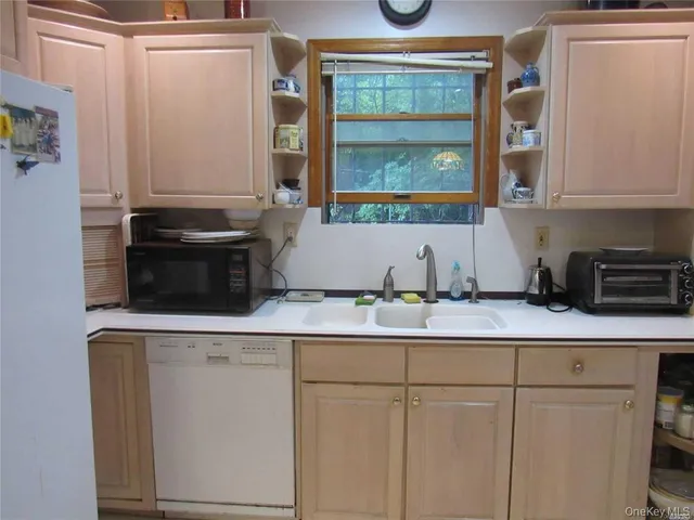 a kitchen with stainless steel appliances granite countertop a sink and a cabinets