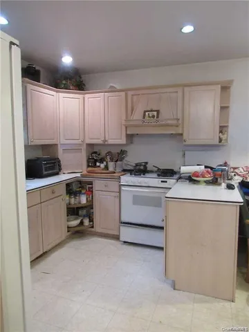 a kitchen with granite countertop white cabinets and white appliances