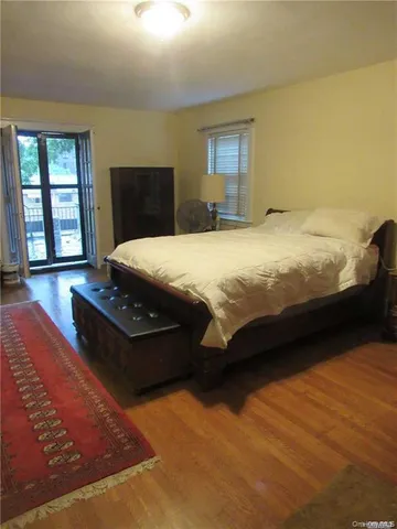 a bedroom with bed and window