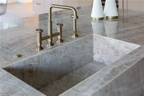 a kitchen with sink stove and cabinets