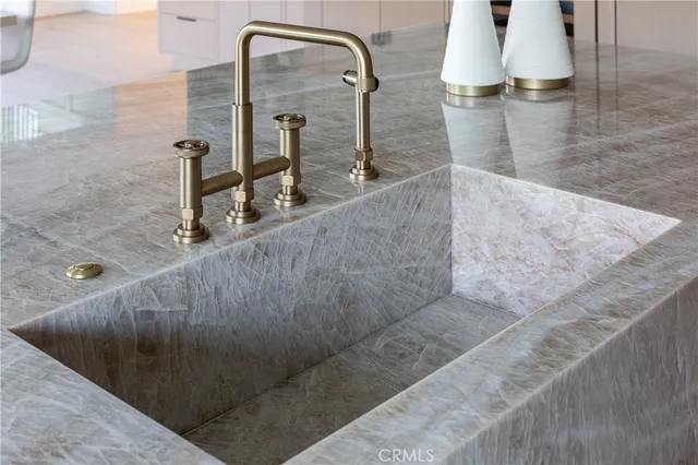 a kitchen with sink stove and cabinets