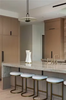 a kitchen with a table chairs stove and cabinets