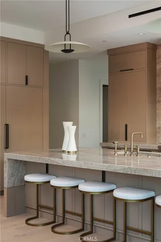 a kitchen with a table chairs stove and cabinets