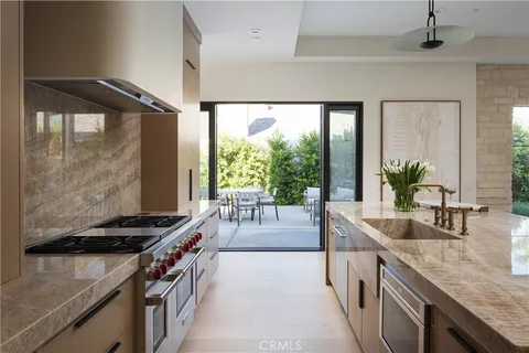 a kitchen with stainless steel appliances granite countertop a stove and a sink