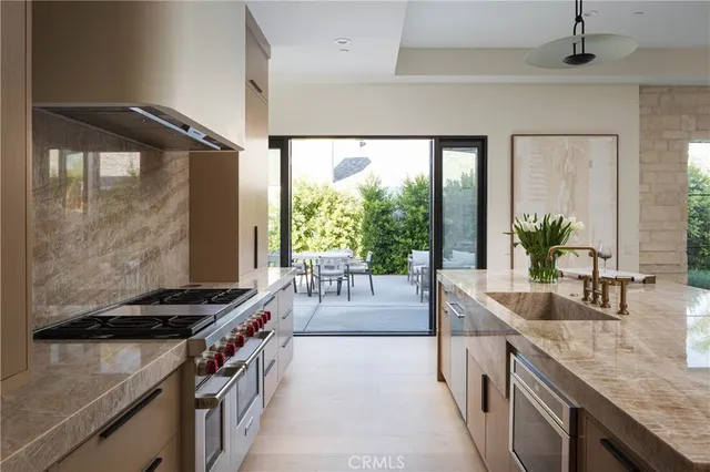 a kitchen with stainless steel appliances granite countertop a stove and a sink