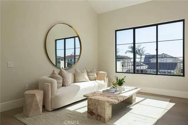 a bedroom with furniture and a large window