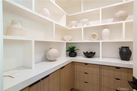 a living room with furniture a chandelier and a large window