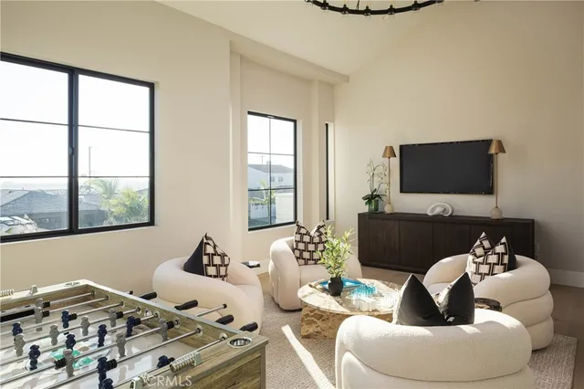 a bedroom with a large bed and a chandelier