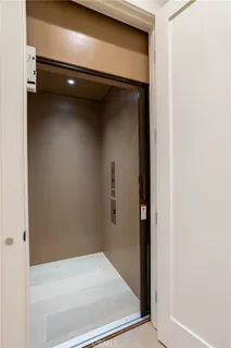 an aerial view of a city with lots of residential buildings and ocean view in back