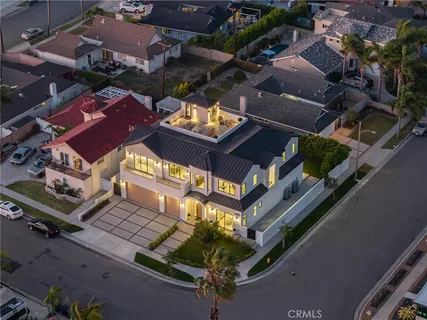 a view of a patio with couches chairs potted plants and floor to ceiling window