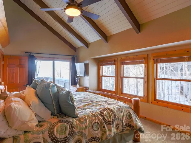 a bed sitting in a bedroom next to a window