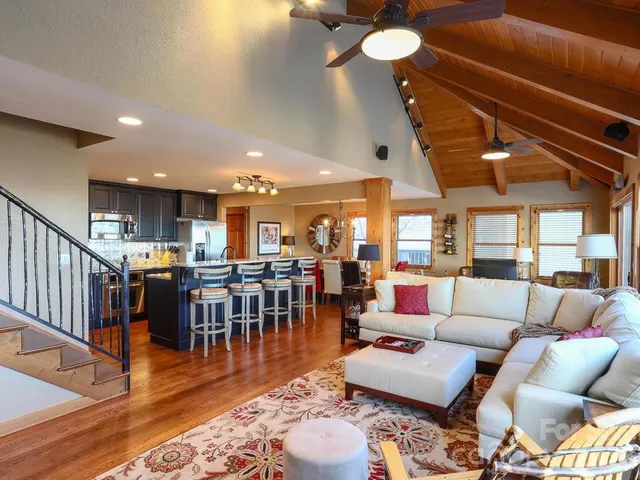 a living room with lots of furniture and a wooden floor