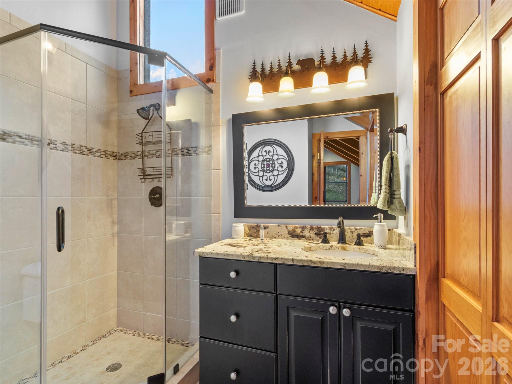 71 Ivy Ridge Road Burnsville, NC 28714 - Photo 17 of 23 a bathroom with a sink and a mirror