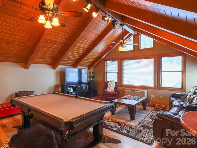 a living room with furniture a air conditioner vent and a window