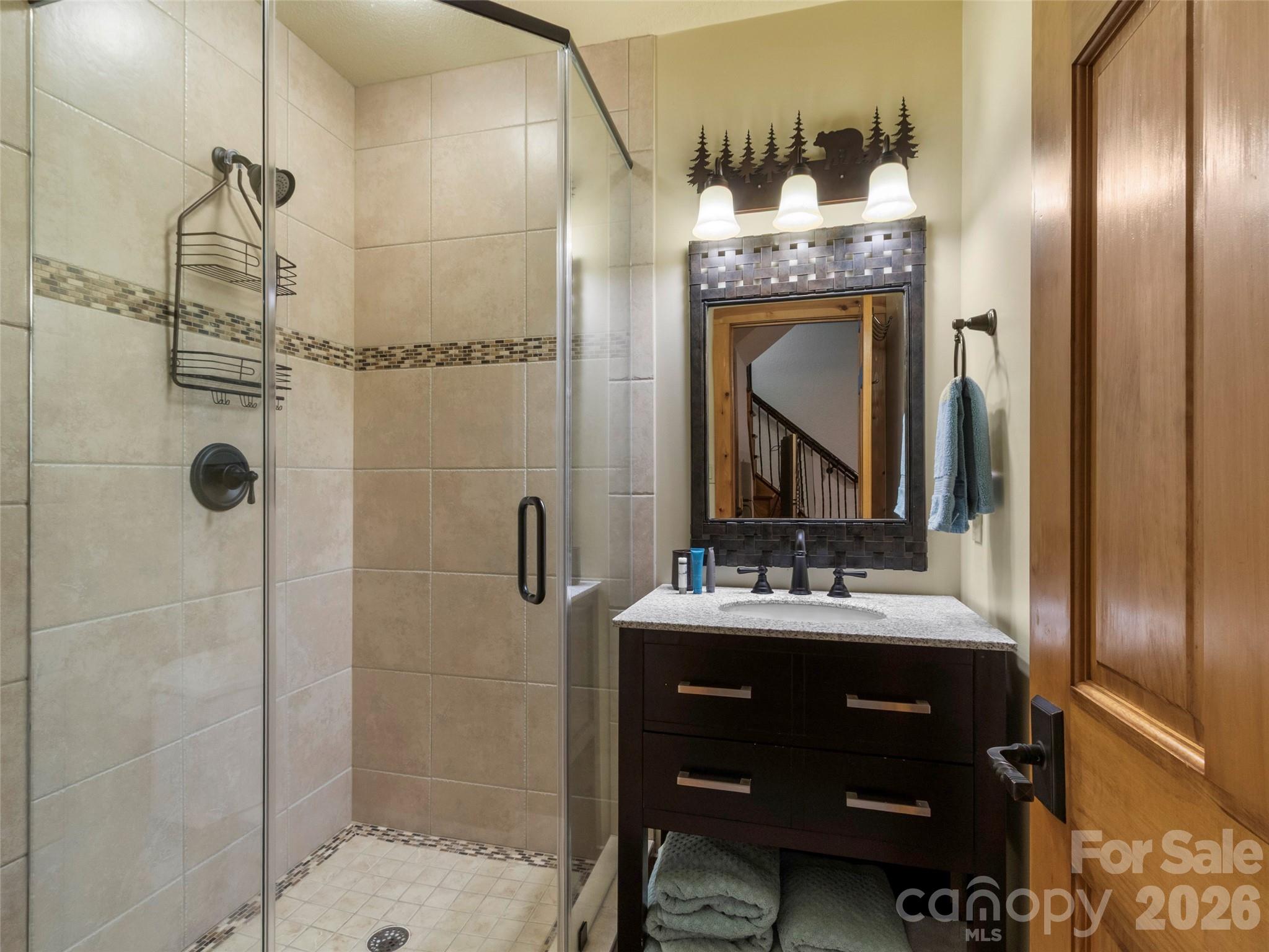71 Ivy Ridge Road Burnsville, NC 28714 - Photo 19 of 23 a bathroom with a double vanity sink mirror and shower