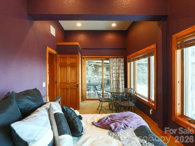 a bedroom with a large bed and a large window