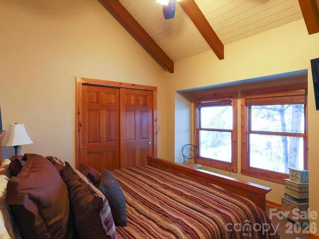 a bed sitting in a bedroom next to a window