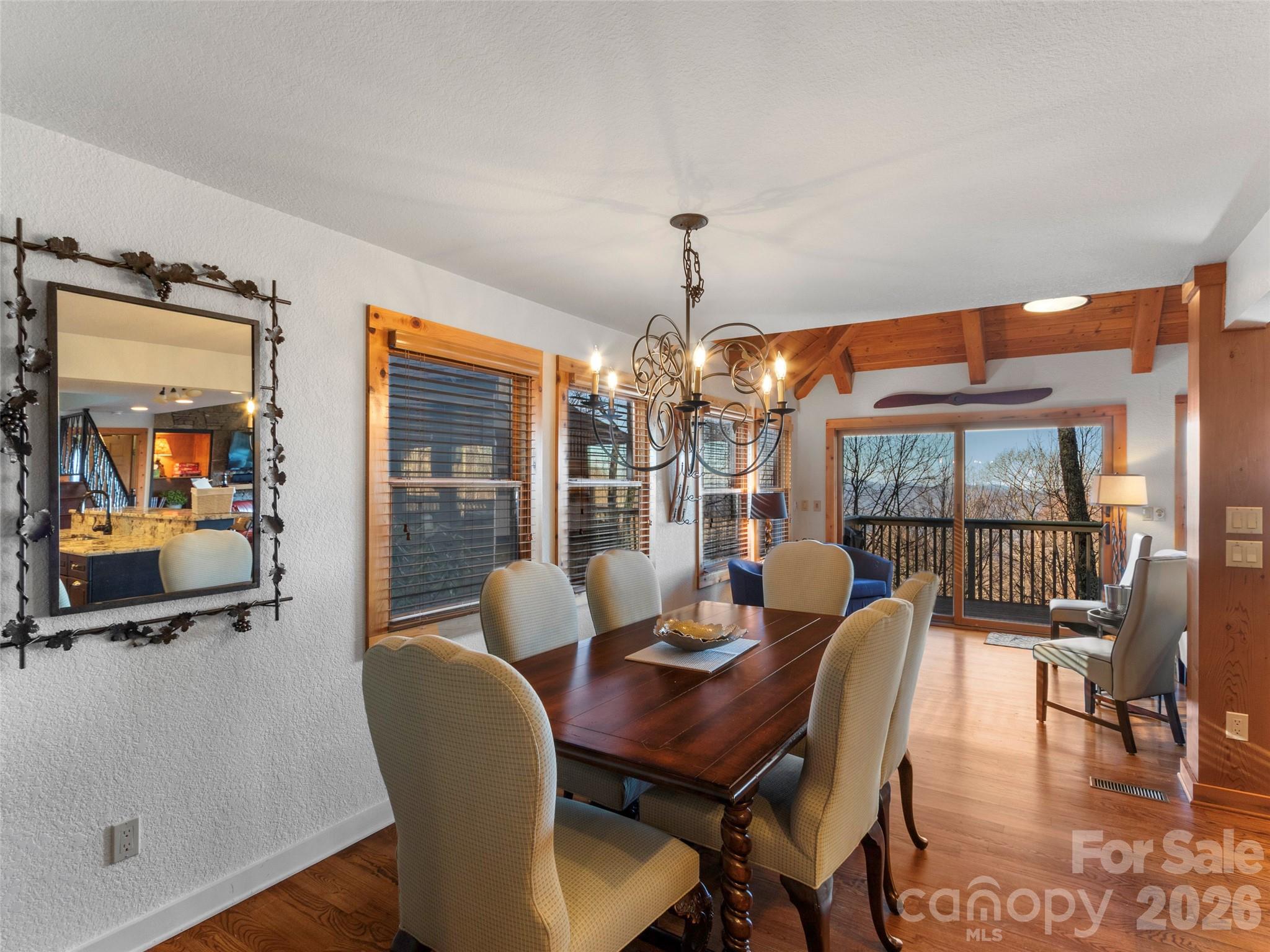 71 Ivy Ridge Road Burnsville, NC 28714 - Photo 7 of 23 a dining room with furniture a chandelier and wooden floor