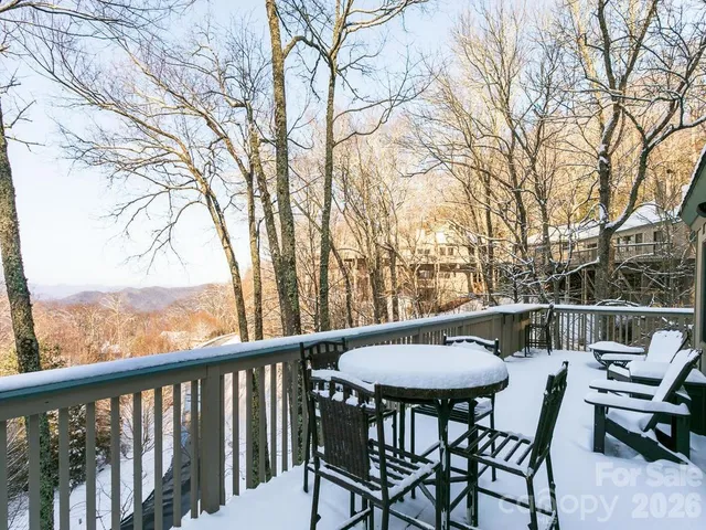 a view of a chairs and table in the balcony