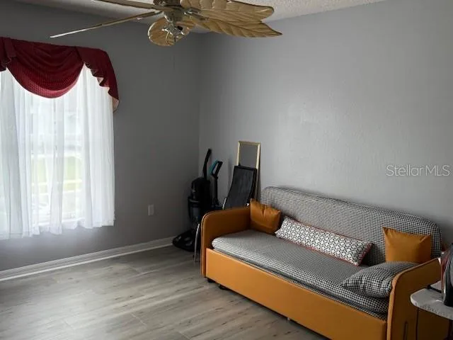 a blue couch sitting in a room next to a window