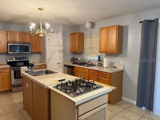 a kitchen with a sink stove and refrigerator
