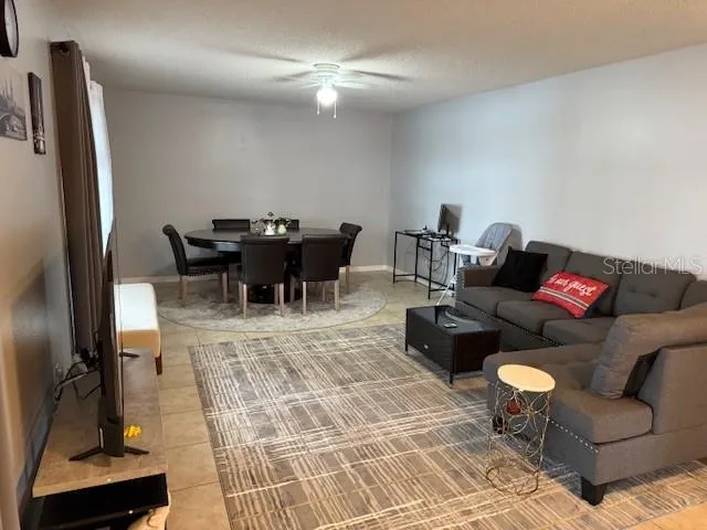 a living room with furniture and a dining table