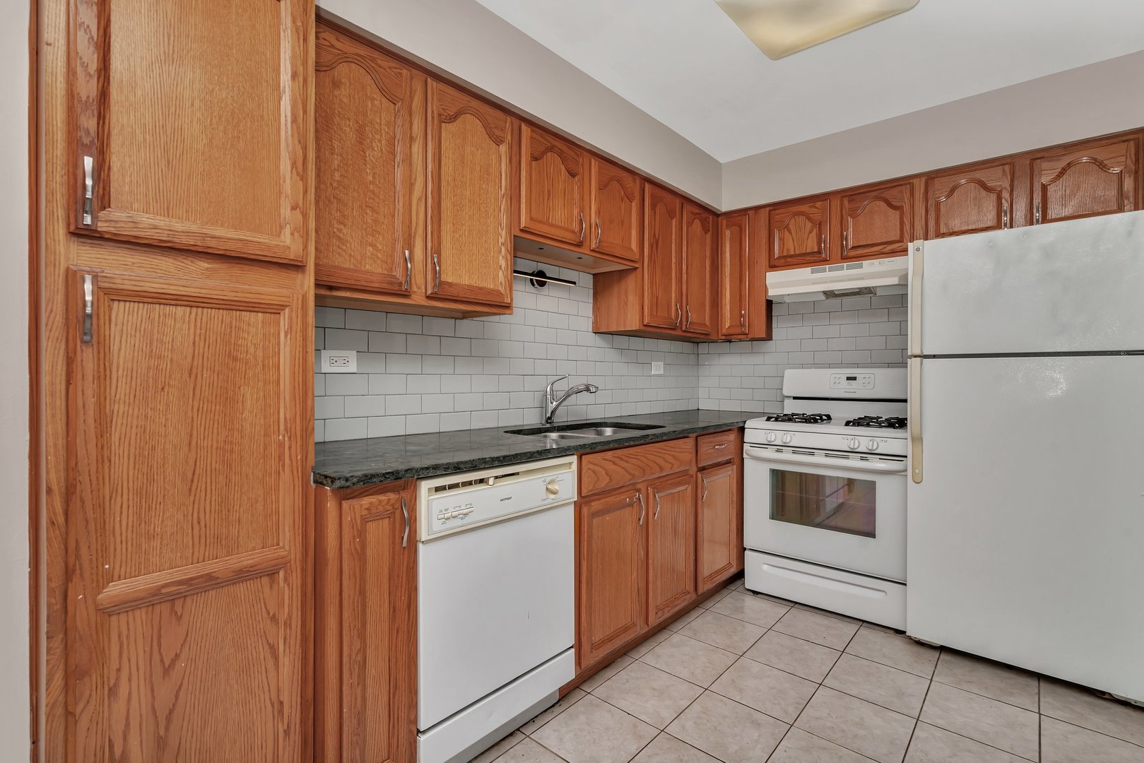 5724 West 111th Street, Unit 3A Chicago Ridge, IL 60415 - Photo 7 of 12 a kitchen with stainless steel appliances granite countertop a refrigerator sink and cabinets