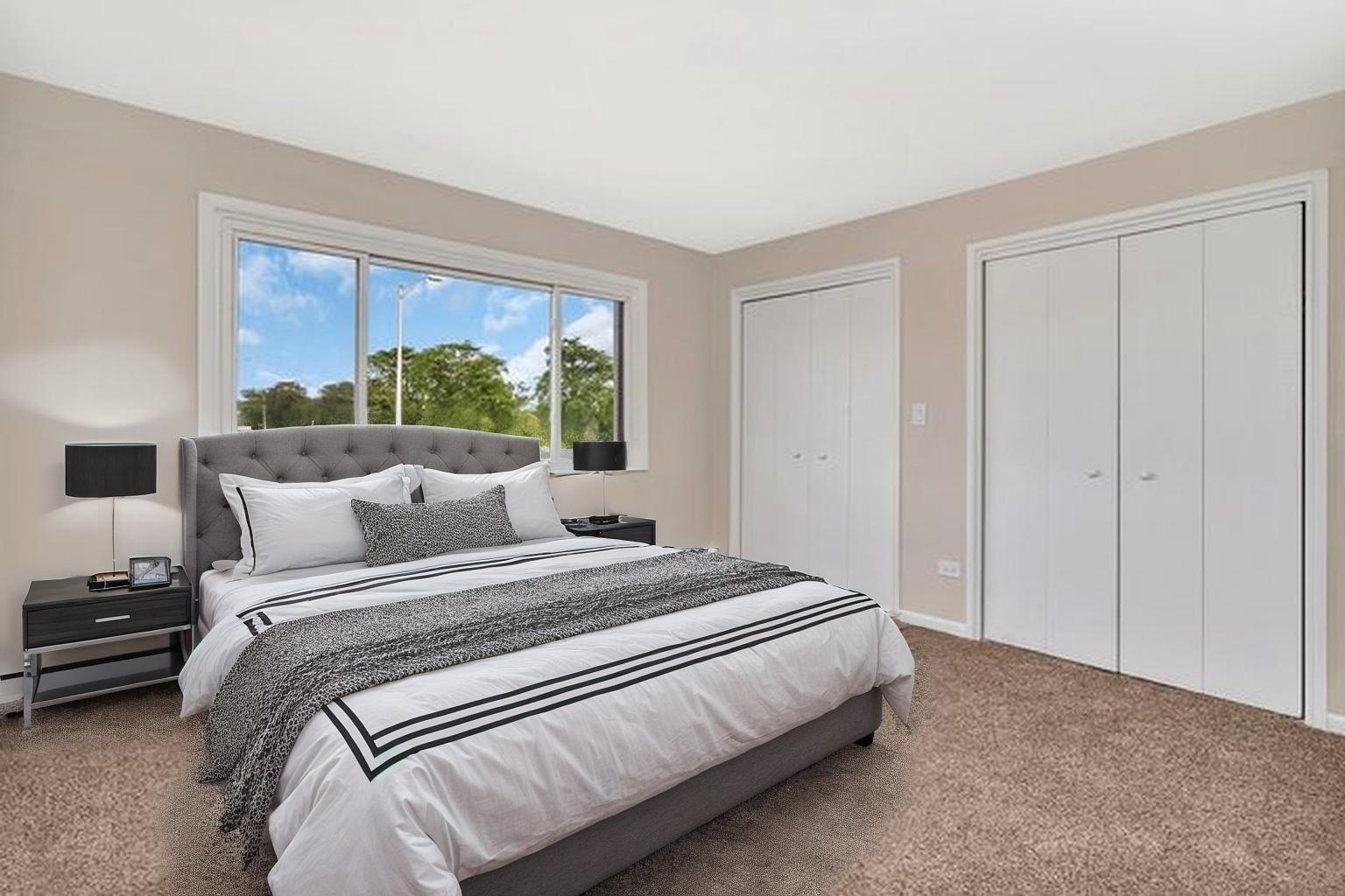 5724 West 111th Street, Unit 3A Chicago Ridge, IL 60415 - Photo 9 of 12 a bedroom with a bed and a large window