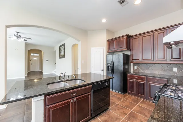 a bathroom with a granite countertop sink a large mirror and vanity