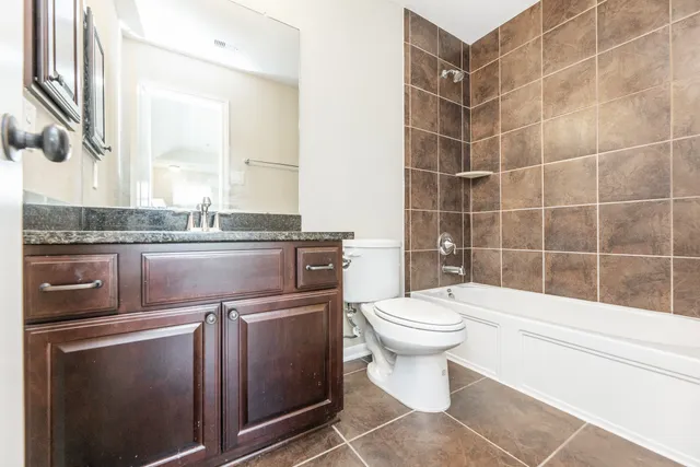 a view of backyard of house with wooden fence