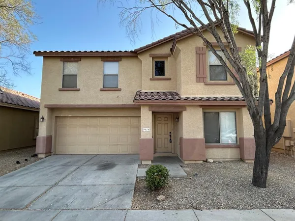 a front view of a house with garage