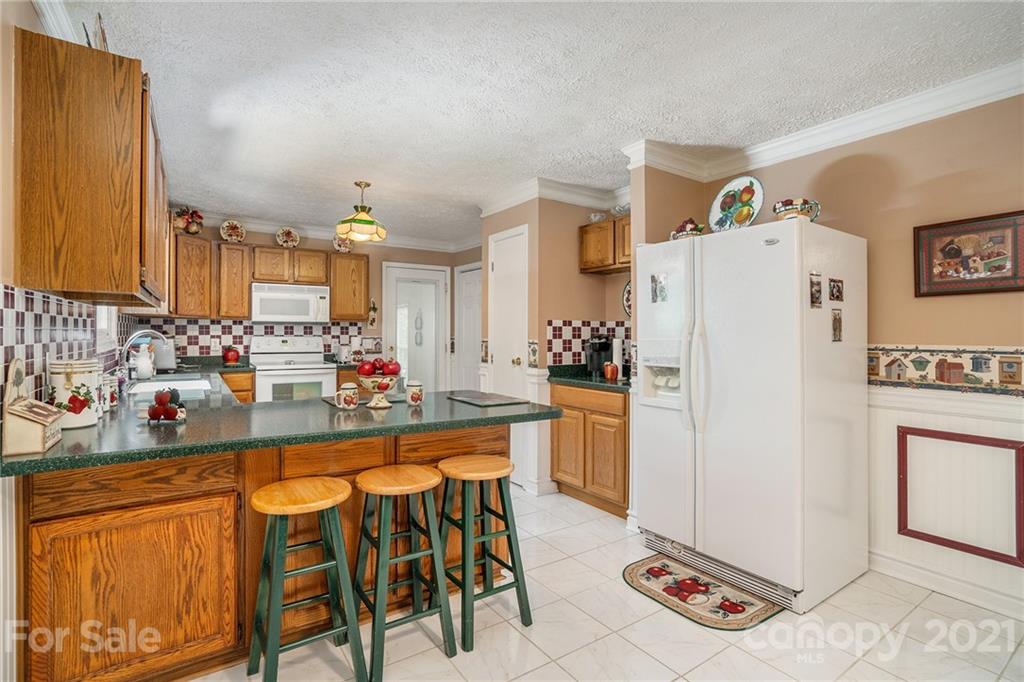 1251 Crossland Road Clover, SC 29710 - Photo 11 of 45 a kitchen with stainless steel appliances granite countertop a refrigerator and a stove top oven