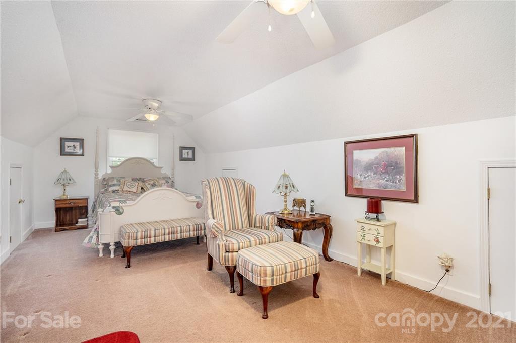 1251 Crossland Road Clover, SC 29710 - Photo 34 of 45 a spacious bedroom with a bed and a chair