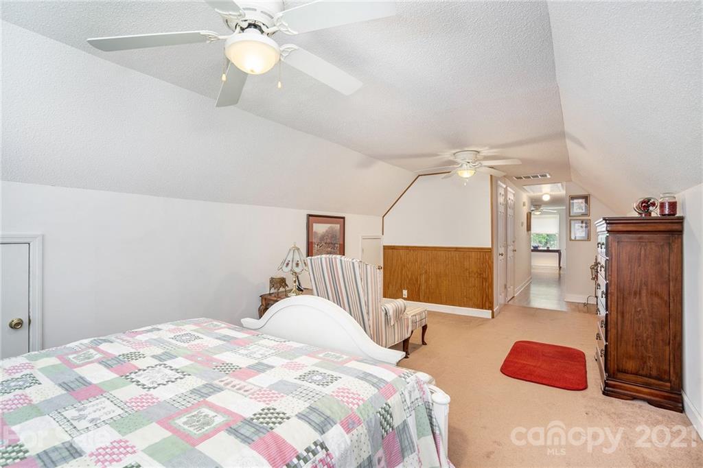 1251 Crossland Road Clover, SC 29710 - Photo 35 of 45 a bedroom with a large bed and a chandelier