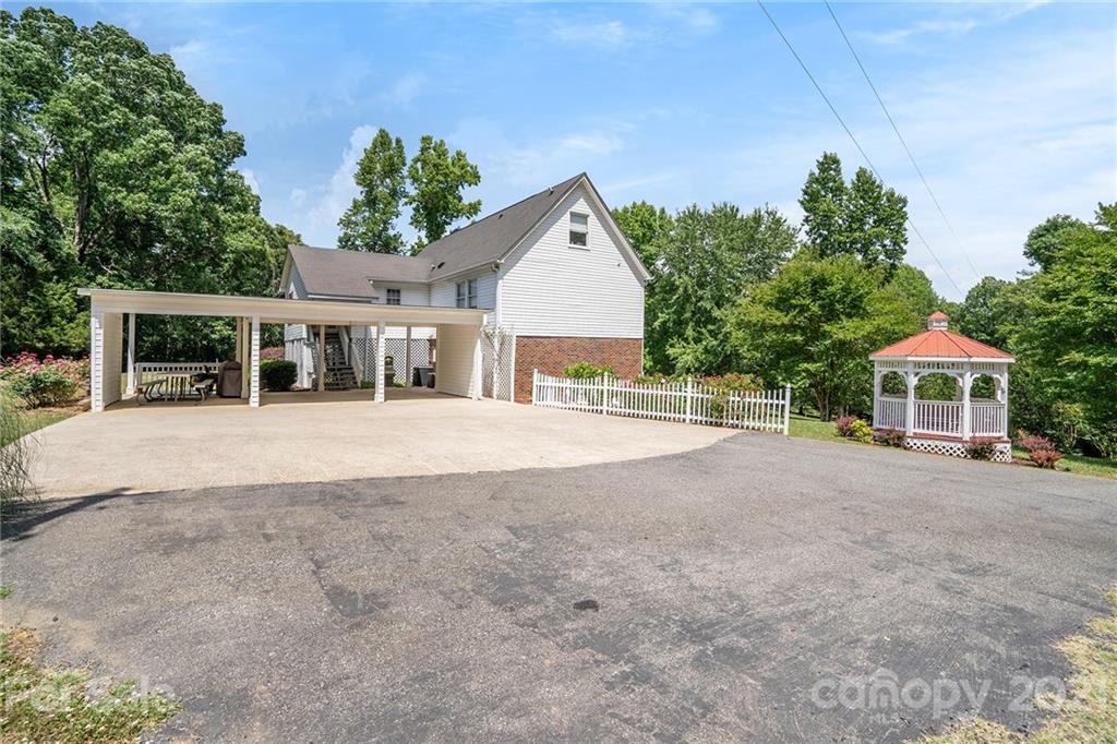 1251 Crossland Road Clover, SC 29710 - Photo 40 of 45 a view of a house with a yard and potted plants